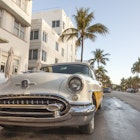 MIAMI, USA - MAR 10, 2017: Vintage american car parked at the famous Art Deco hotels in the Ocean Drive in Miami Beach. Florida, United States