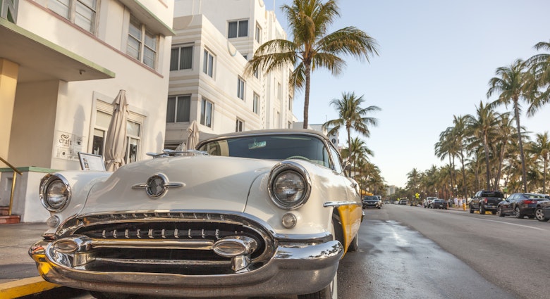 MIAMI, USA - MAR 10, 2017: Vintage american car parked at the famous Art Deco hotels in the Ocean Drive in Miami Beach. Florida, United States