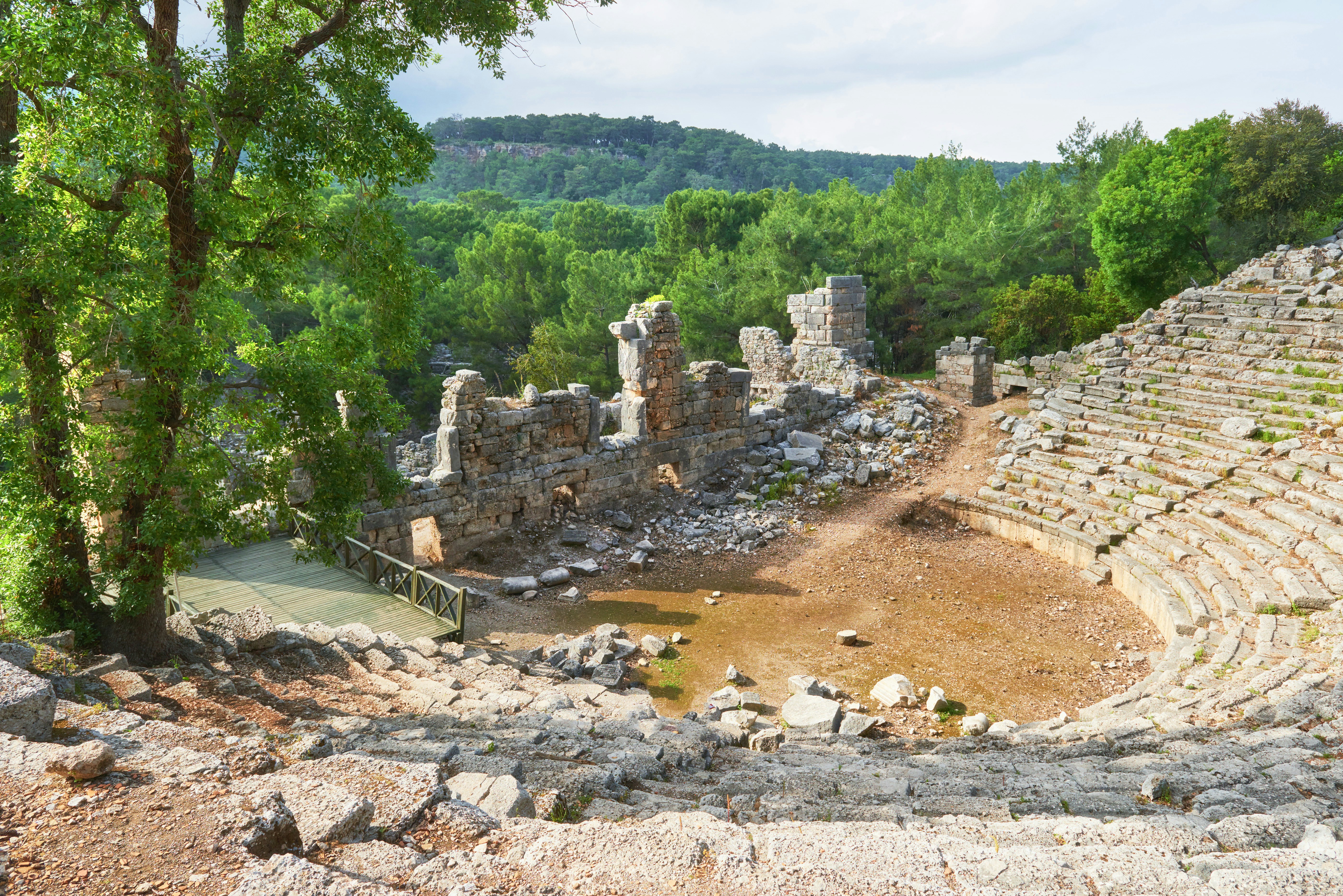 A semi-ruined amphitheater facing a crumbling stone wall at Troy in Turkey.