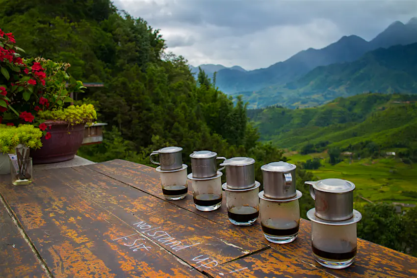 Vietnamese coffees line the bench top of a picturesque Sapa cafe. Vietnamese coffees line the bench top of a picturesque Sapa cafe.