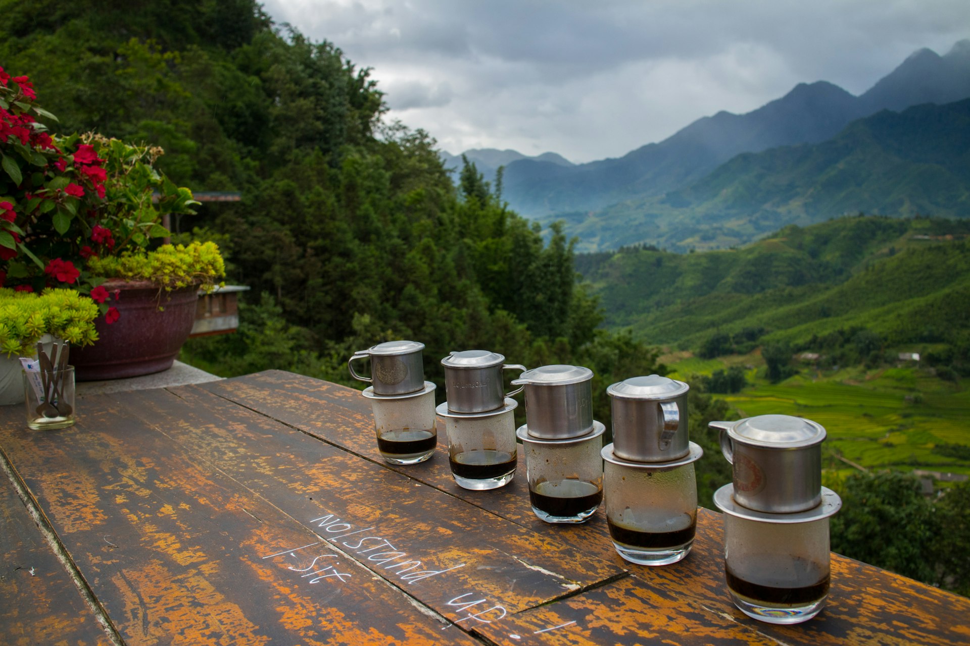Vietnamese coffees line the bench top of a picturesque Sapa cafe. 