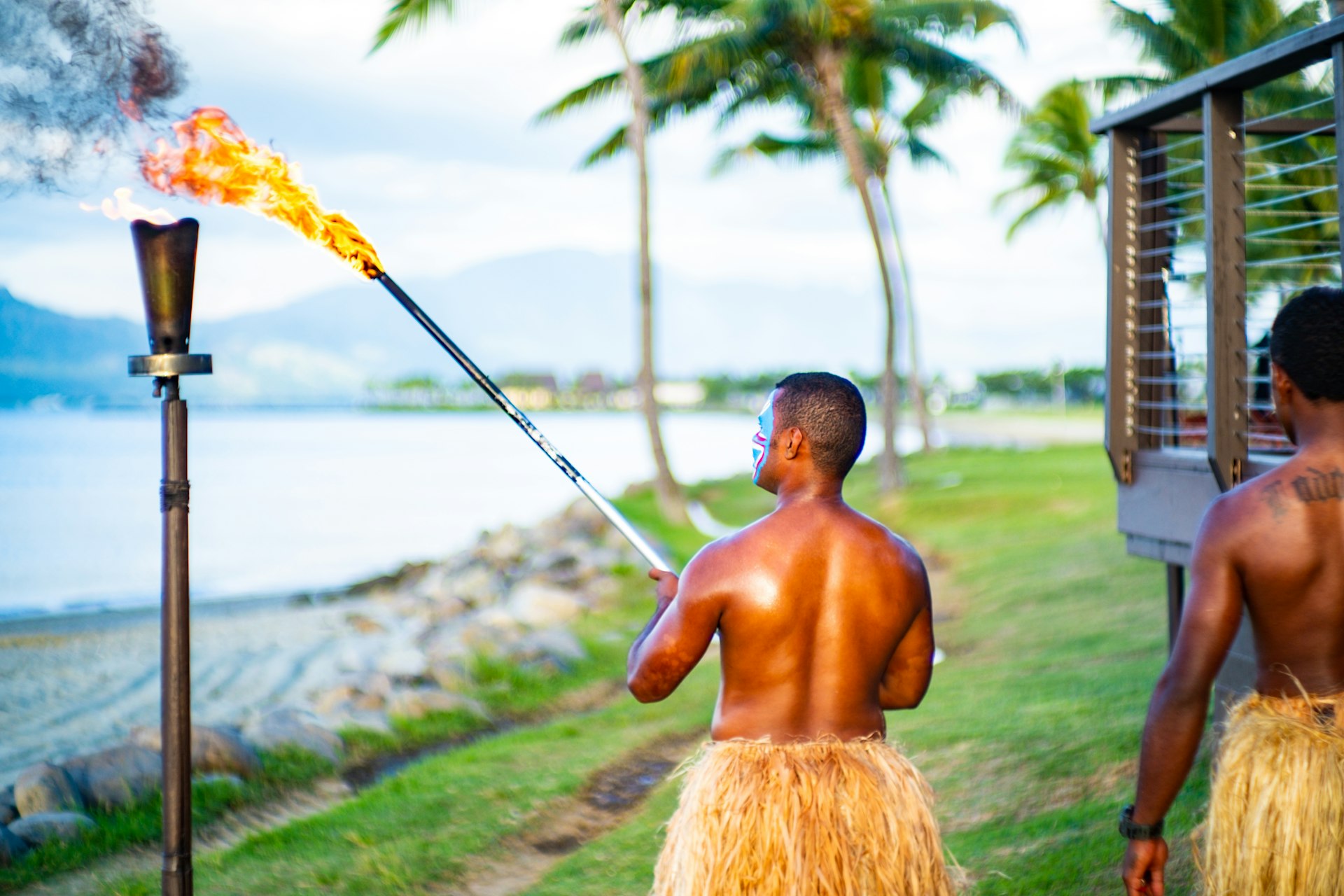  Fijian people performing the lighting of the beach torches.