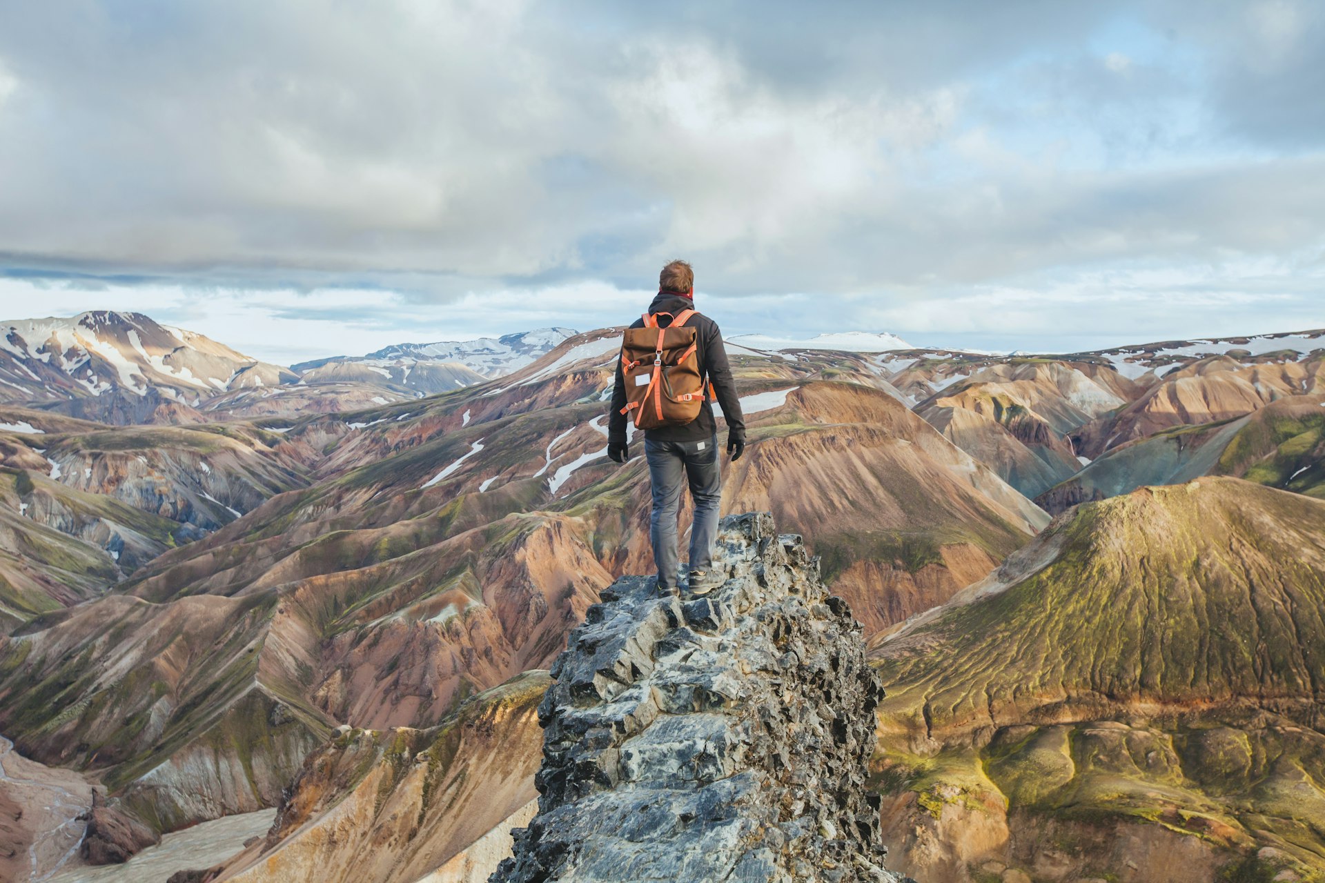 The back of a man hiking Iceland's Landmannalaugar