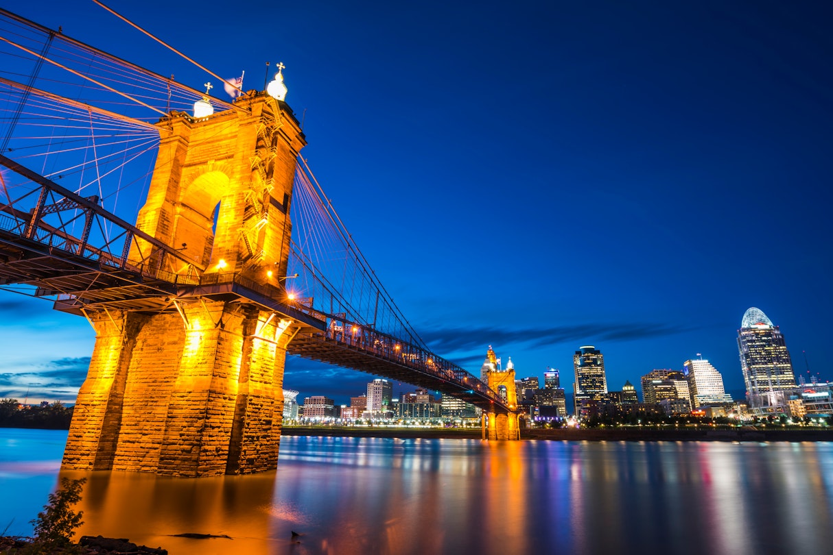 John A. Roebling Suspension Bridge at night with the Cincinnati skyline in the background
