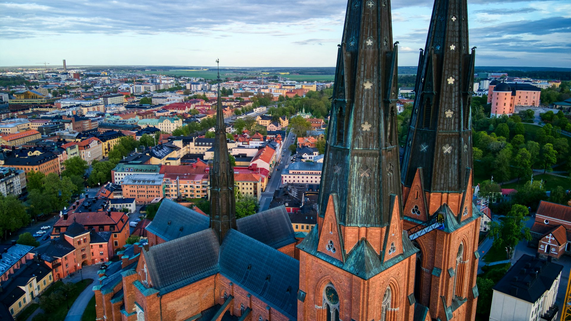A shot taken near the steeples of a large church looking down over city roofs
