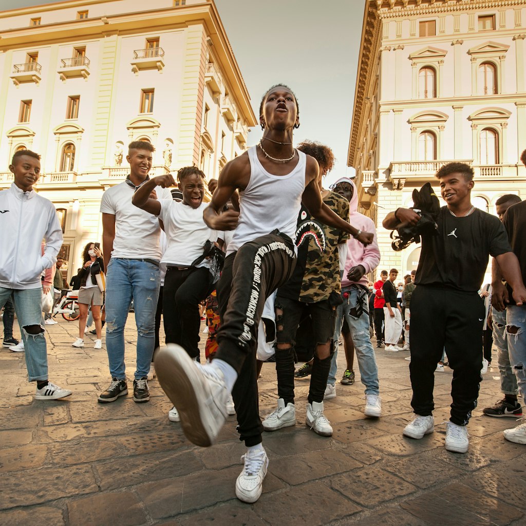 Unidentified B-boy break dancers perform in the street for the crowd. Hip Hop battle at an informal street dance meet.