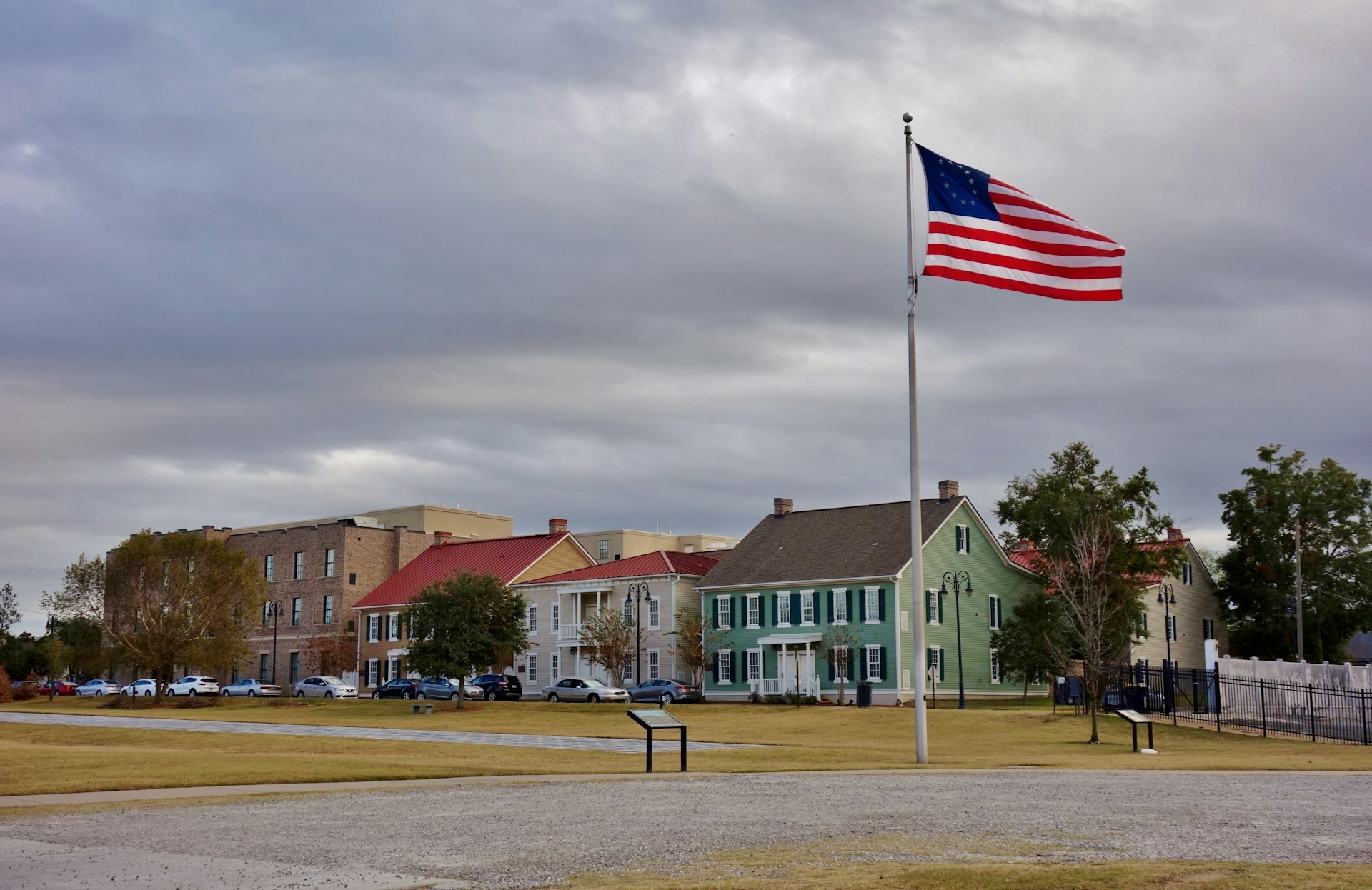 An American flag flies above a large open space lined with grand buildings