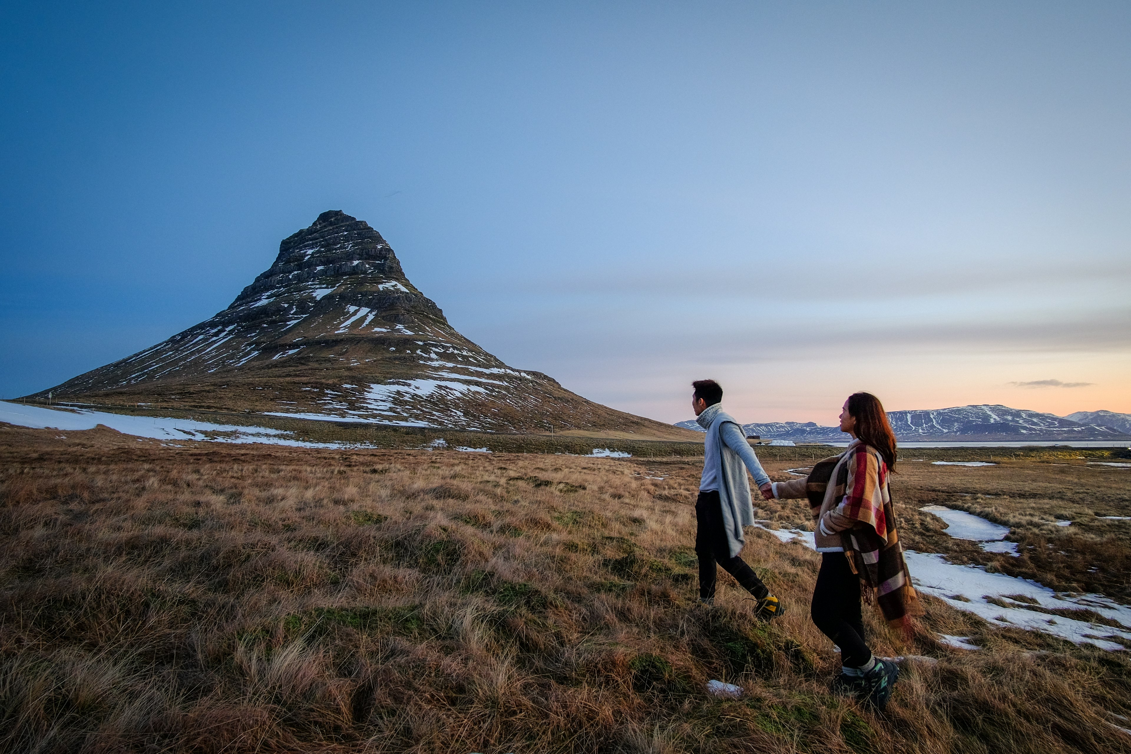 A couple enjoying views of Kirkjufell, Iceland