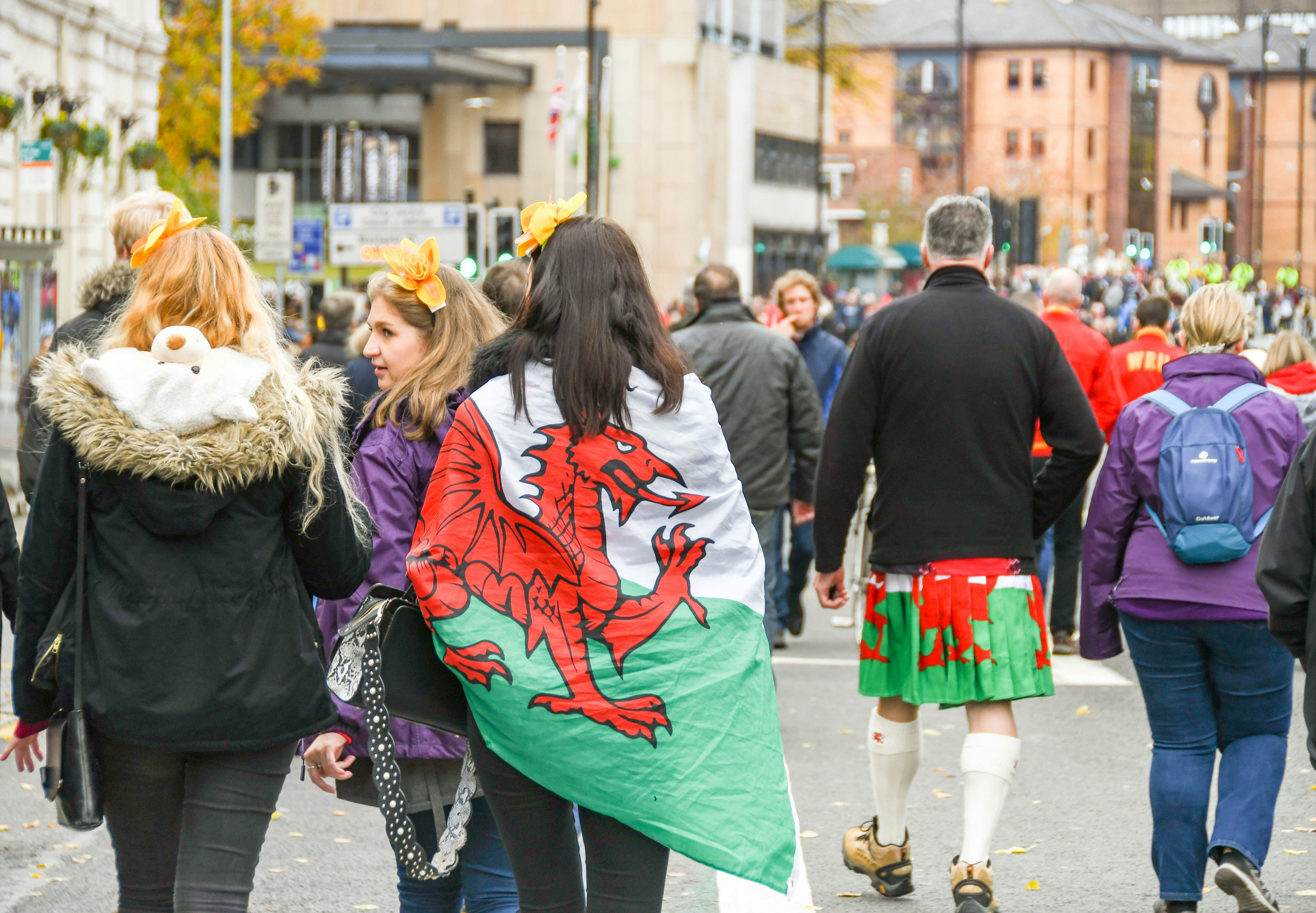 Welsh rugby supporters draped in flags in Cardiff city centre on the day of an international rugby match