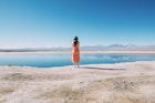 Chile, Atacama Desert, back view of woman standing on edge of Laguna Cejar