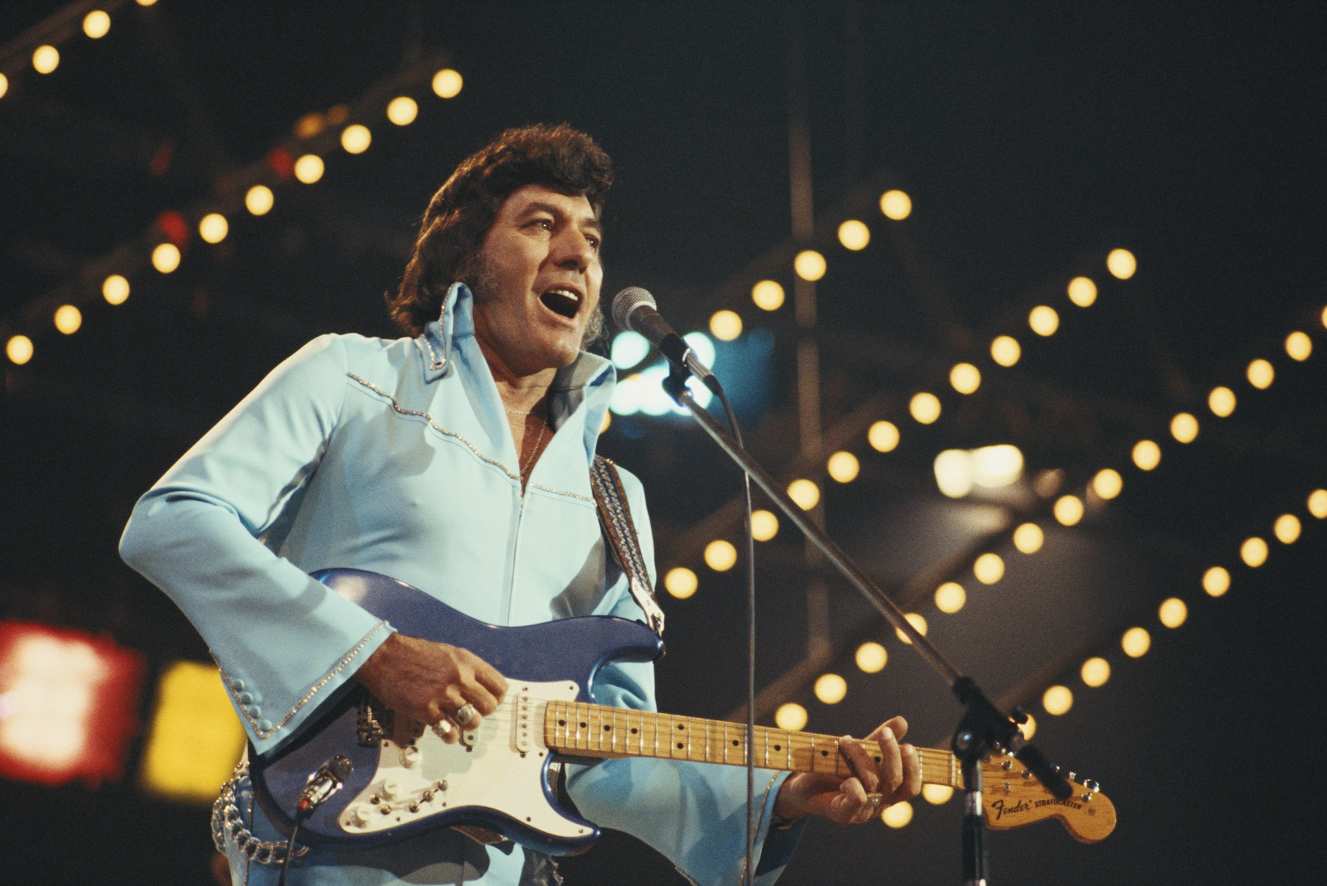 Carl Perkins U.S. rock and roll singer-songwriter and guitarist, playing the guitar during a live concert performance at the International Festival of Country Music, at Wembley Arena, London