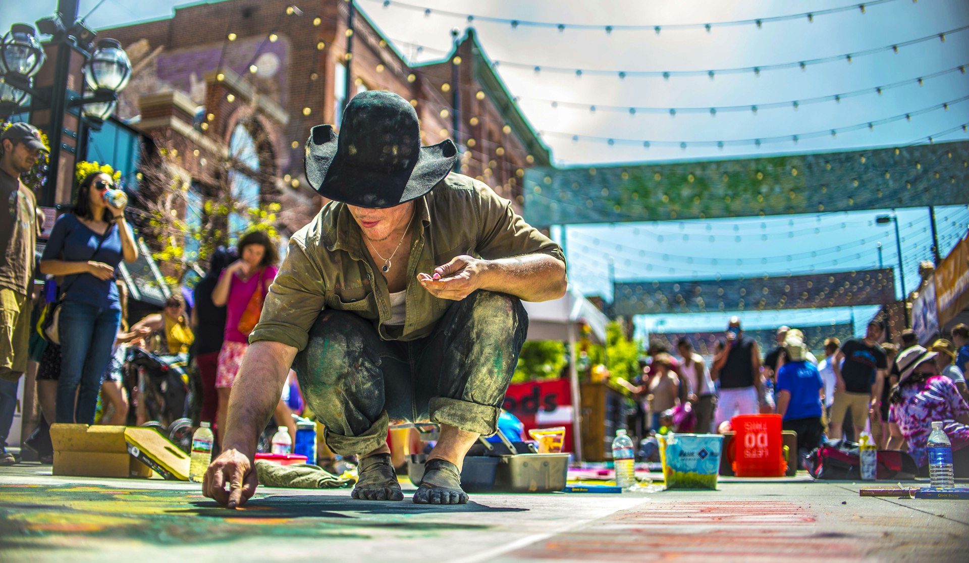 An artist creating sidewalk art at the Chalk Art Festival in Denver, Colorado