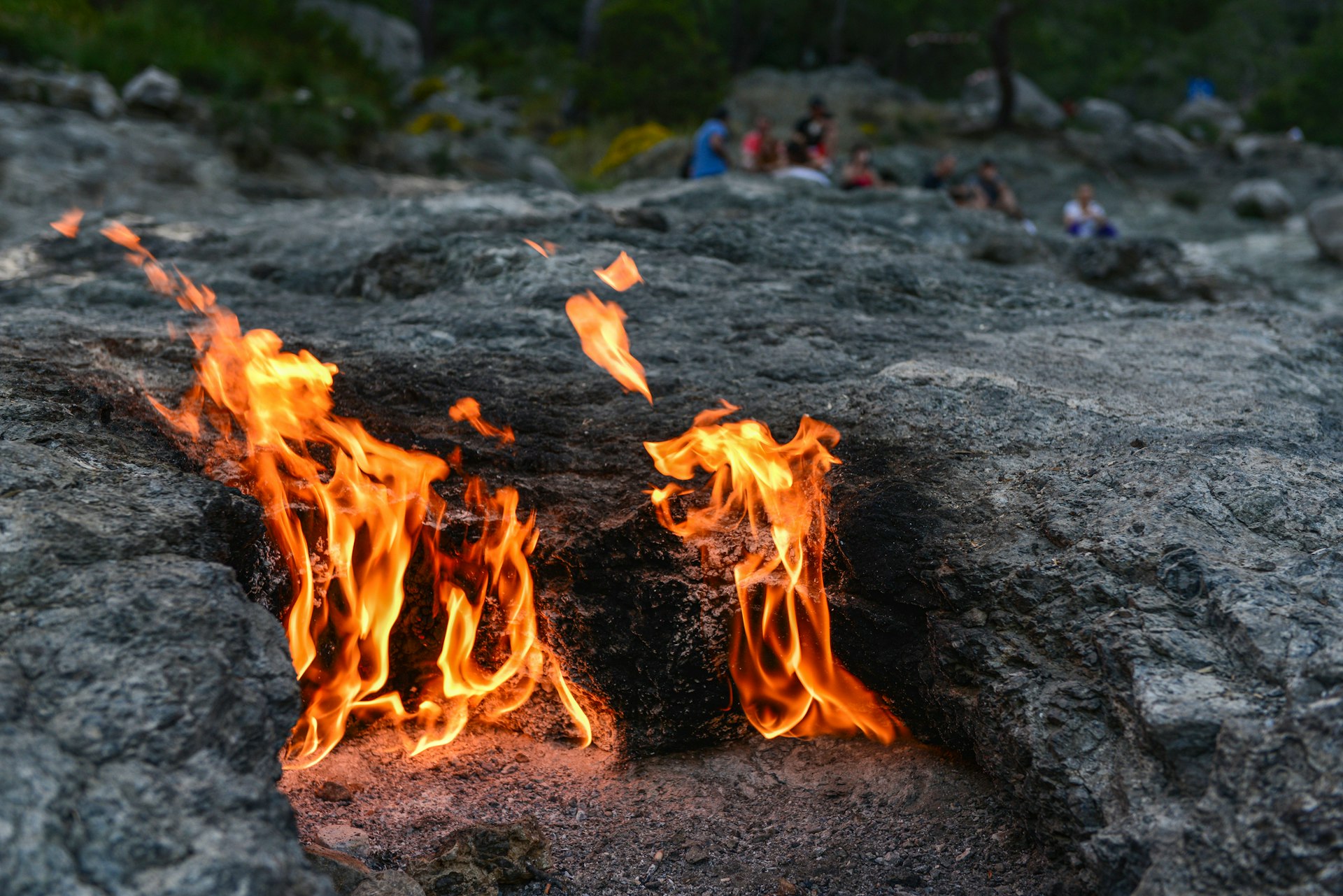 Small flames rise from beneath the rocks at Chimaera in Turkey. A natural phenomenon caused by natural gas escaping from underground and catching alight.