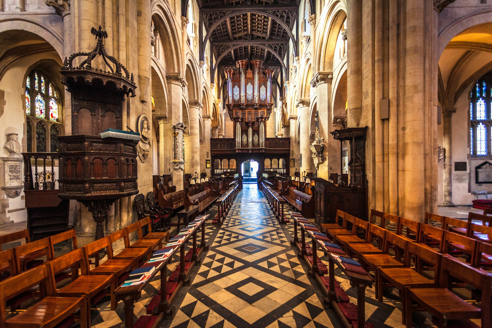 The grand interior of Christ Church Cathedral in Oxford, England. Pews line the walls of the ancient building.