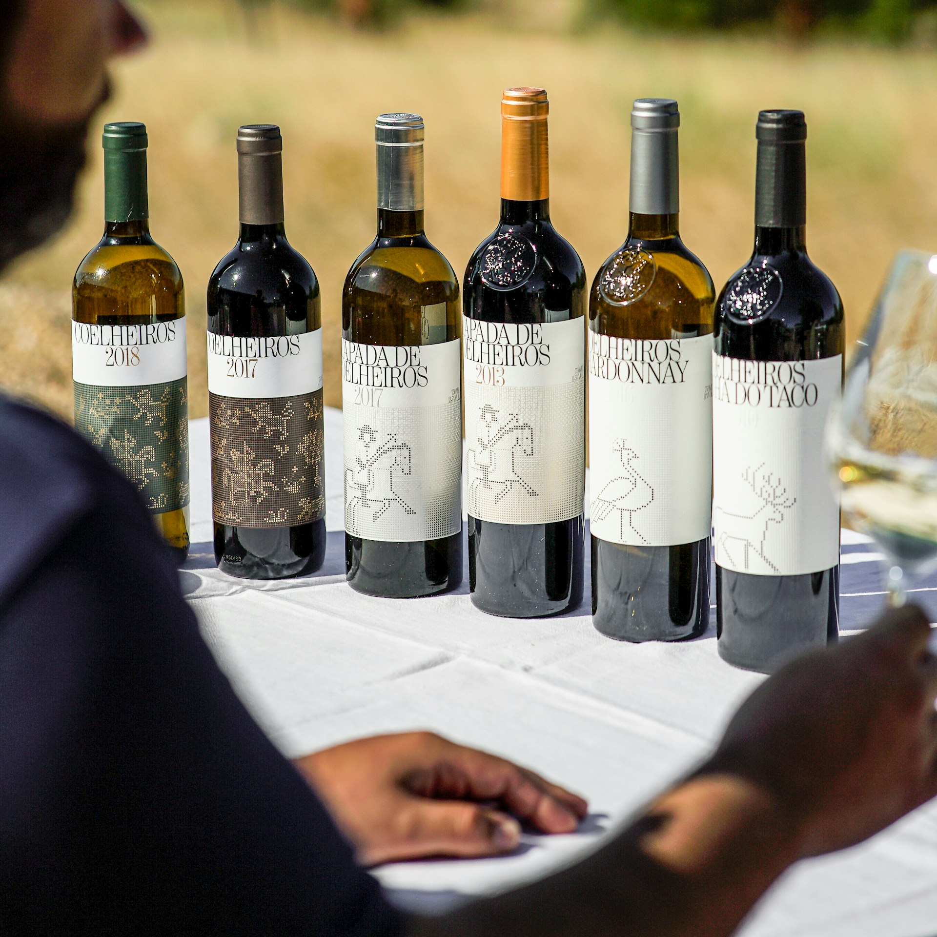 Guests enjoy a wine tasting in the vineyard. 