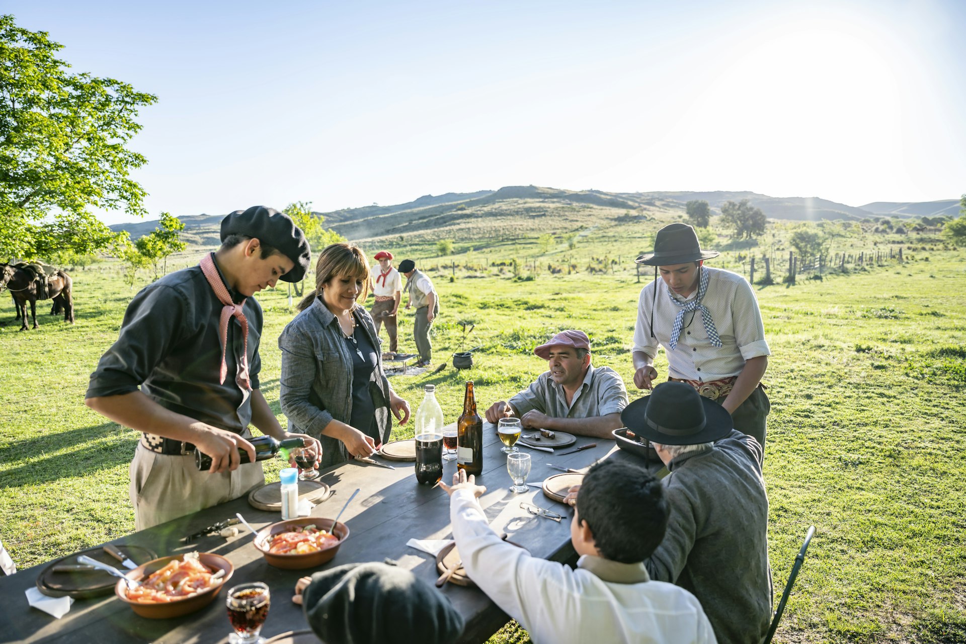 Argentine gaucho family enjoying outdoor midday meal