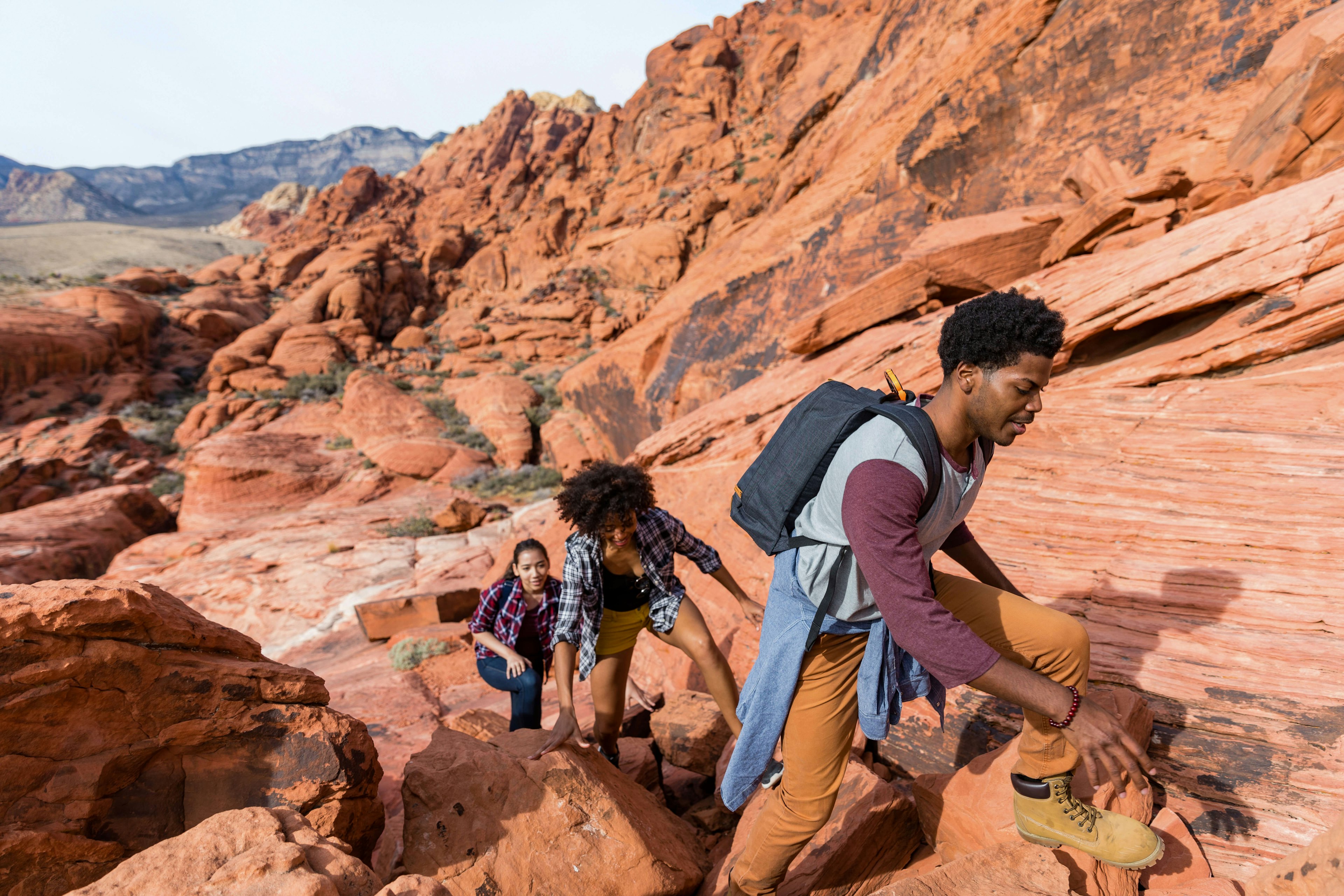 Friends hiking in rock formations during a sunny day cavan images GettyImages-1081446986 rfc.jpg