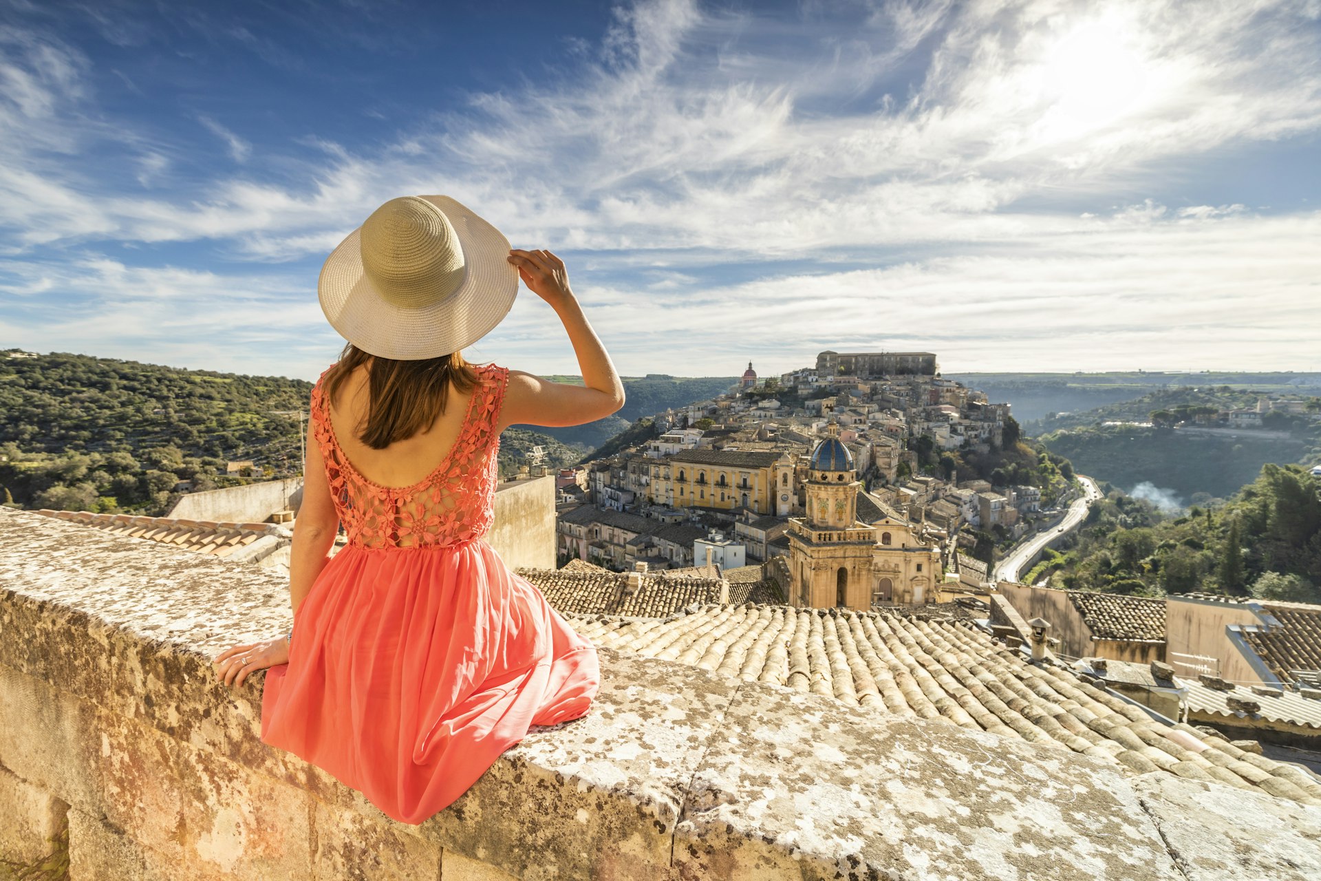 Woman admiring the church of Santa Maria dell'Itria and Ragusa Ibla in the background, Ragusa, Sicily, Italy, Europe