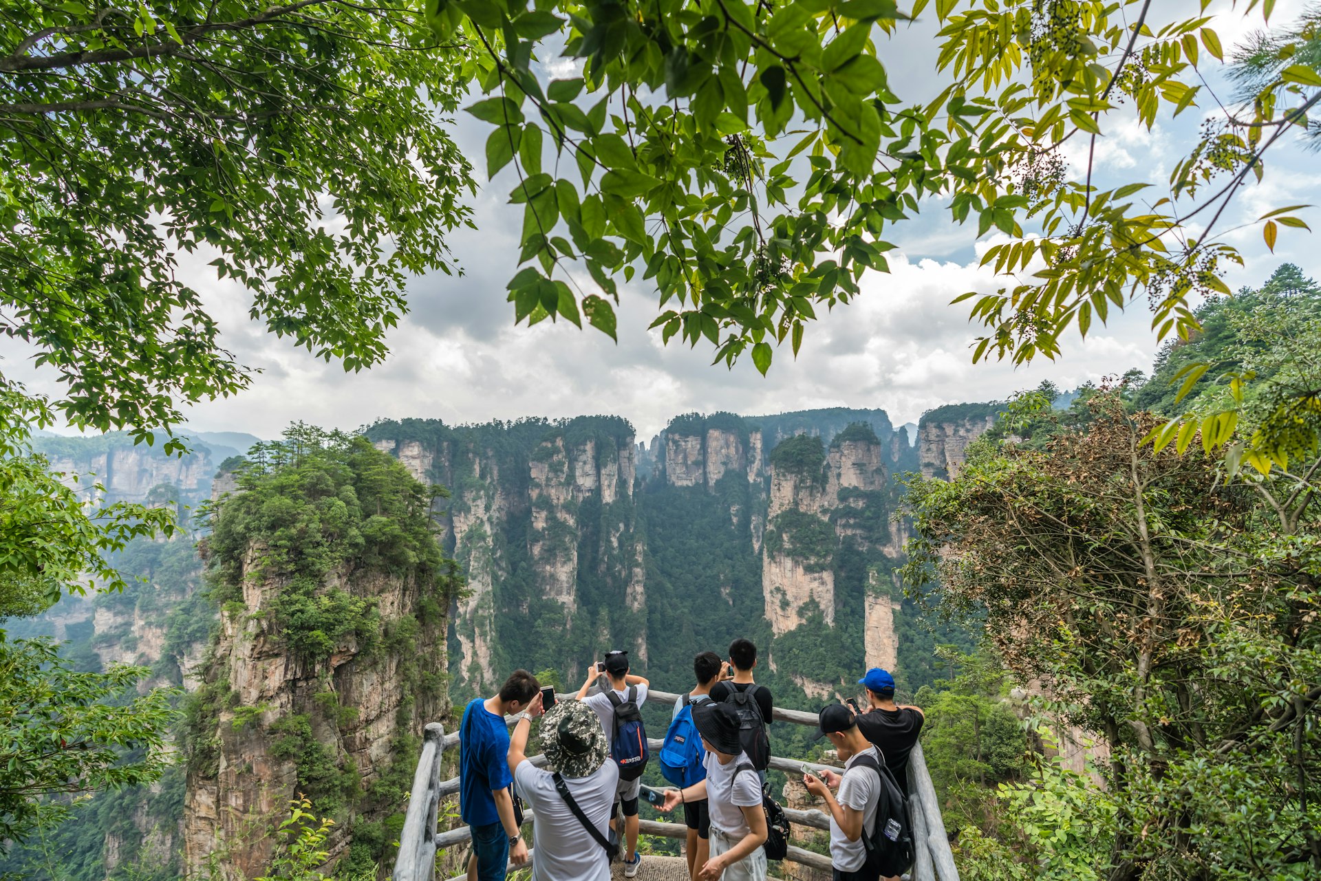 Tourist taking pictures from the viewpoint at Zhangjiajie