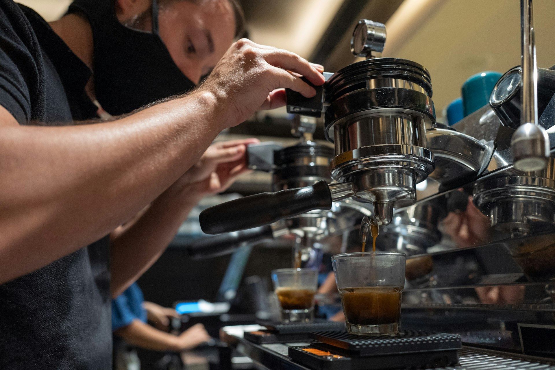 A man makes an espresso at a coffee shop in Medellín