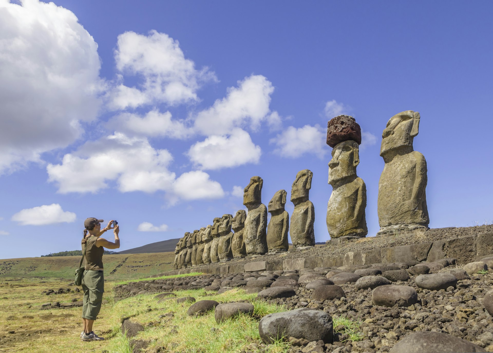 A woman photographing statues at Ahu Tongariki, Easter Island