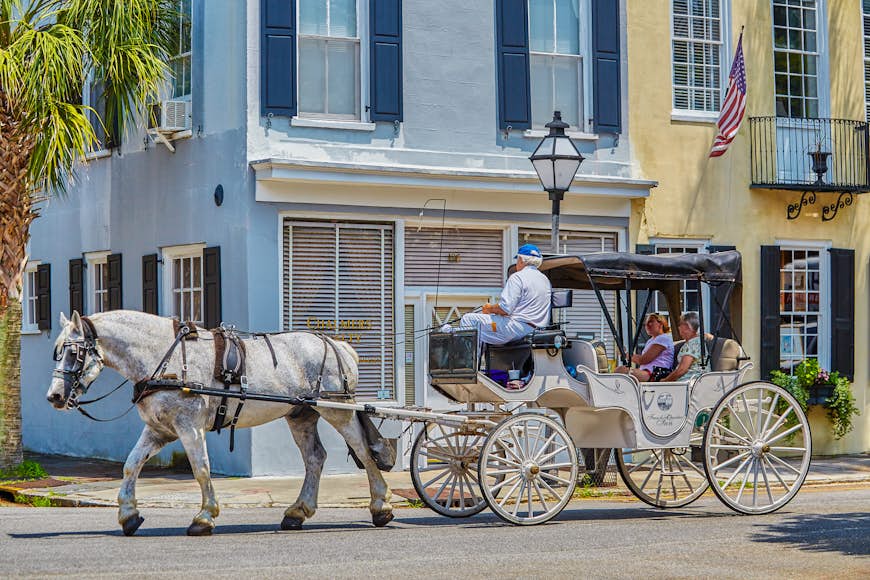 Visitors take a ride on a horse-drawn carriage in Charleston, South Carolina