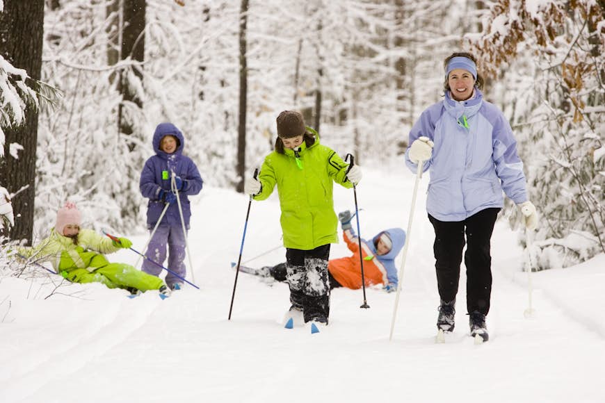 A family group cross country skis along a trail in Dayton, Maine.