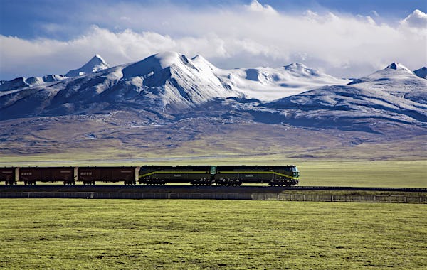 A train on the Qinghai-Tibet Railway, passing in front of snow-capped peaks
