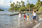 Fijian family playing on the beach.