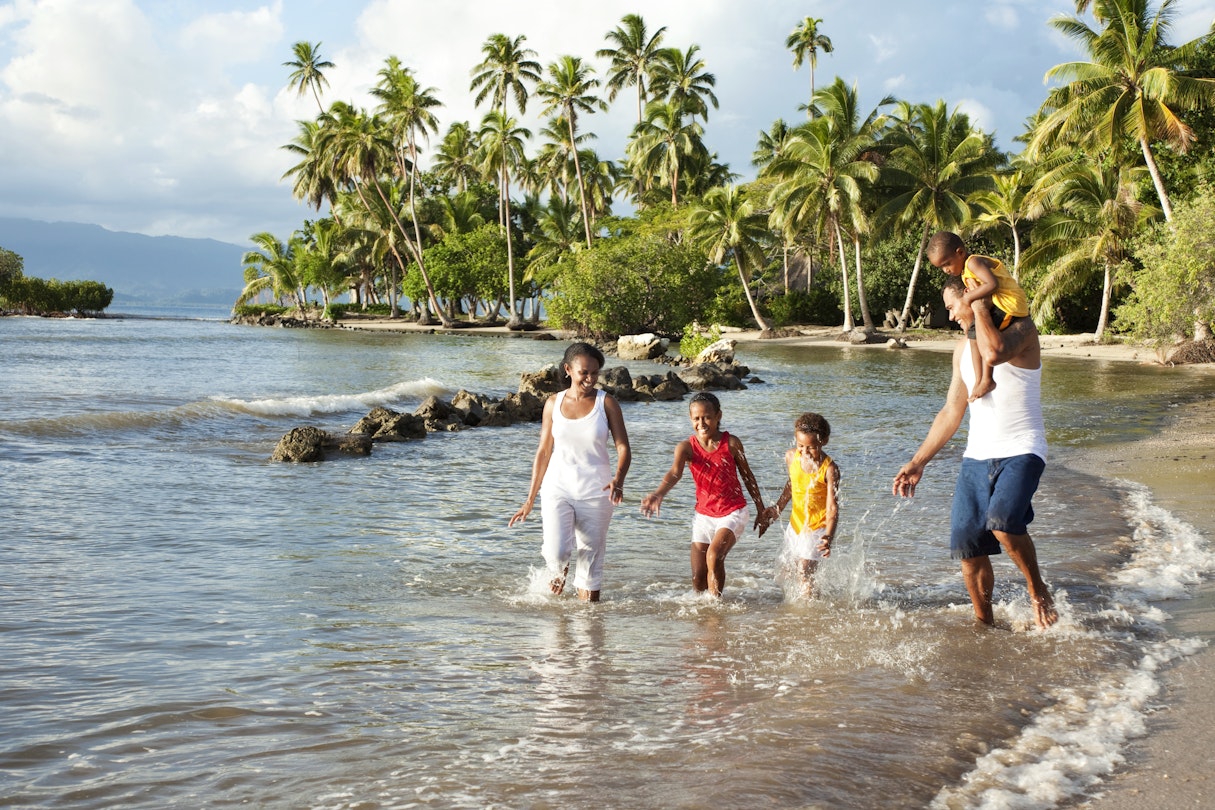 Fijian family playing on the beach.