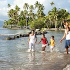 Fijian family playing on the beach.