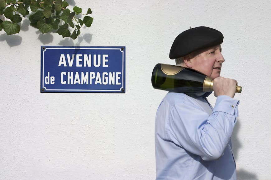 A man holds a bottle of champagne on the 