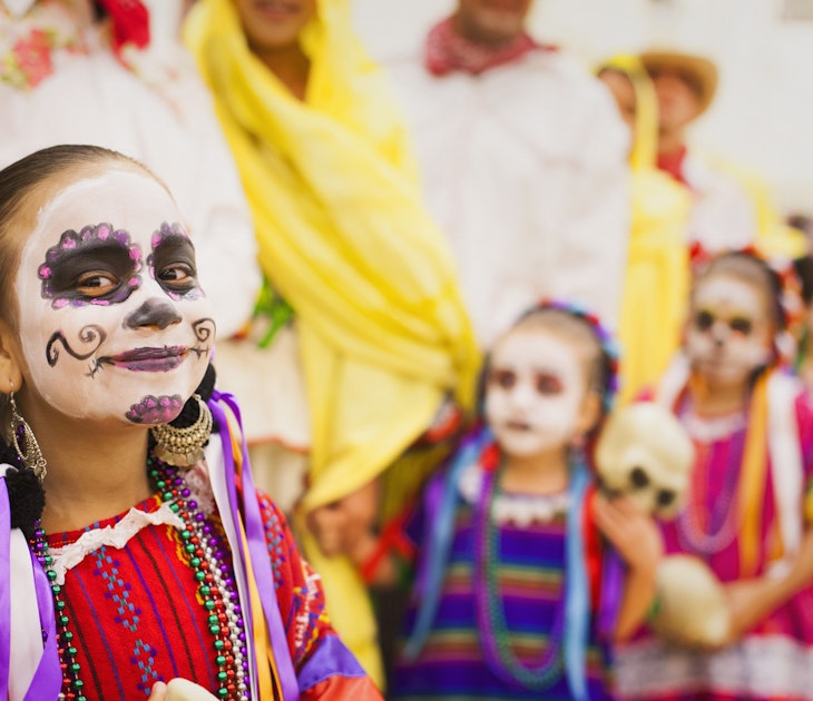Hispanic children with painted faces celebrate Dia de los Muertos in San Francisco.