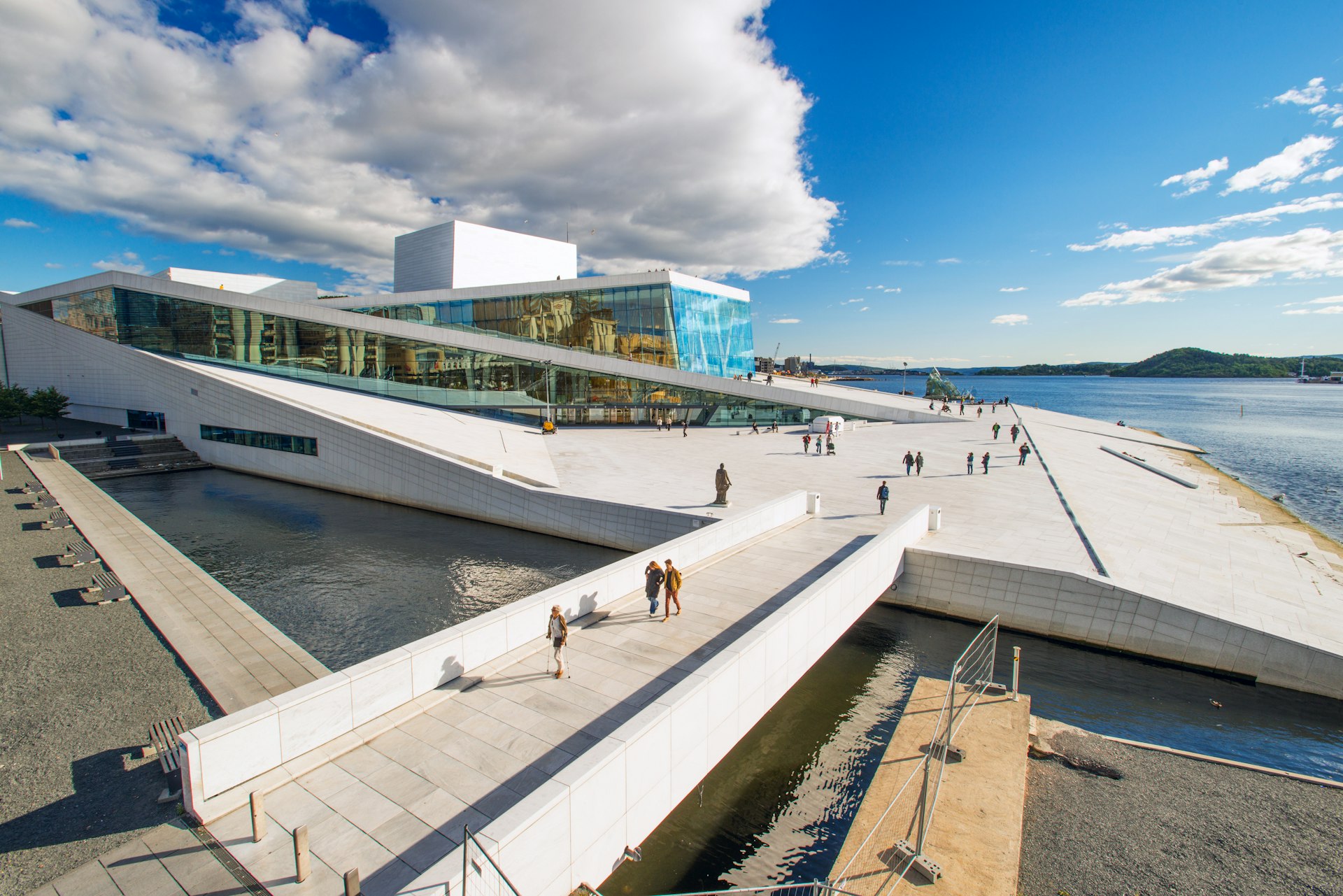 View on a side of the National Oslo Opera House, a white building in Oslo with a 'ramped' design that allows visitors to walk all over it.