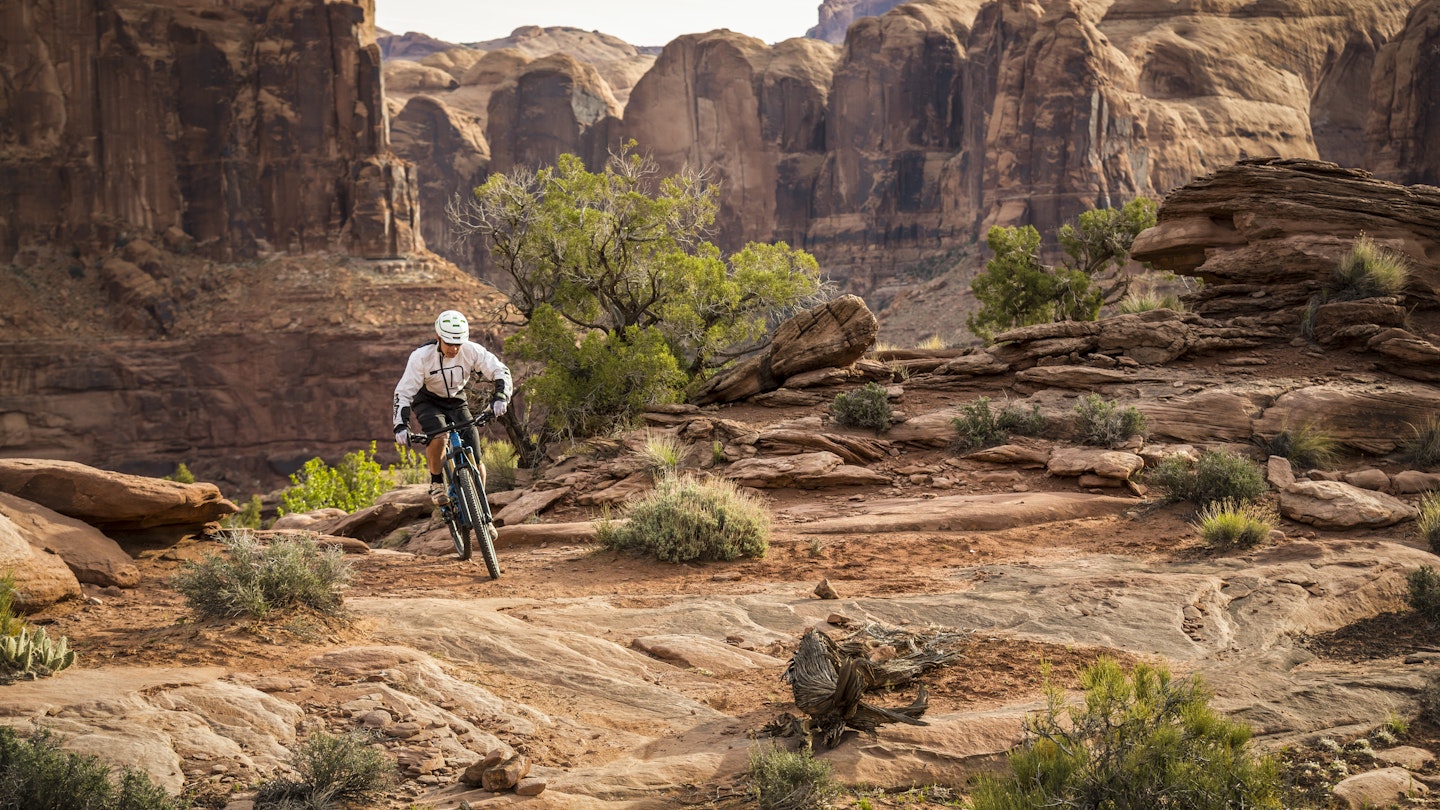 A man mountain biking on the Hymasa trail, Moab, Utah.