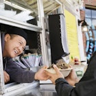 Man buying a bowl of food from a food truck in Richmond.