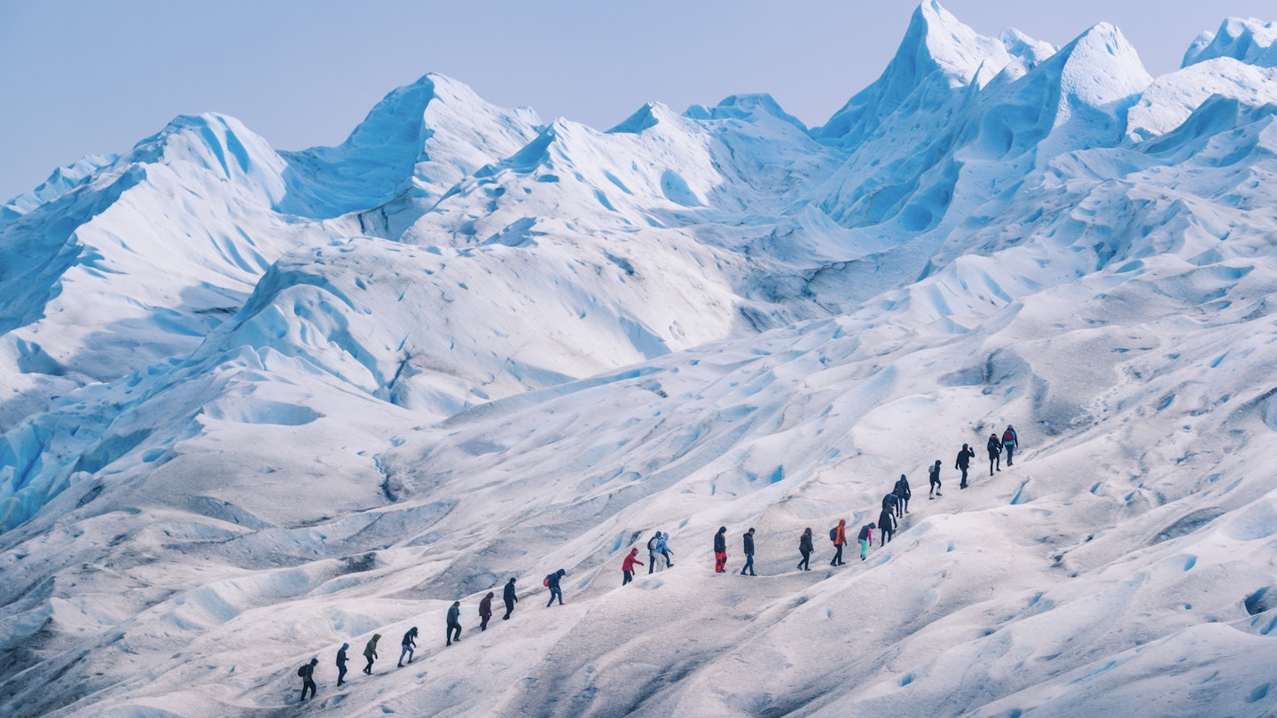 People hiking in a row on the ice of Perito Moreno glacier, Los Glaciares national park, Santa Cruz province, Patagonia Argentina