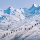 People hiking in a row on the ice of Perito Moreno glacier, Los Glaciares national park, Santa Cruz province, Patagonia Argentina