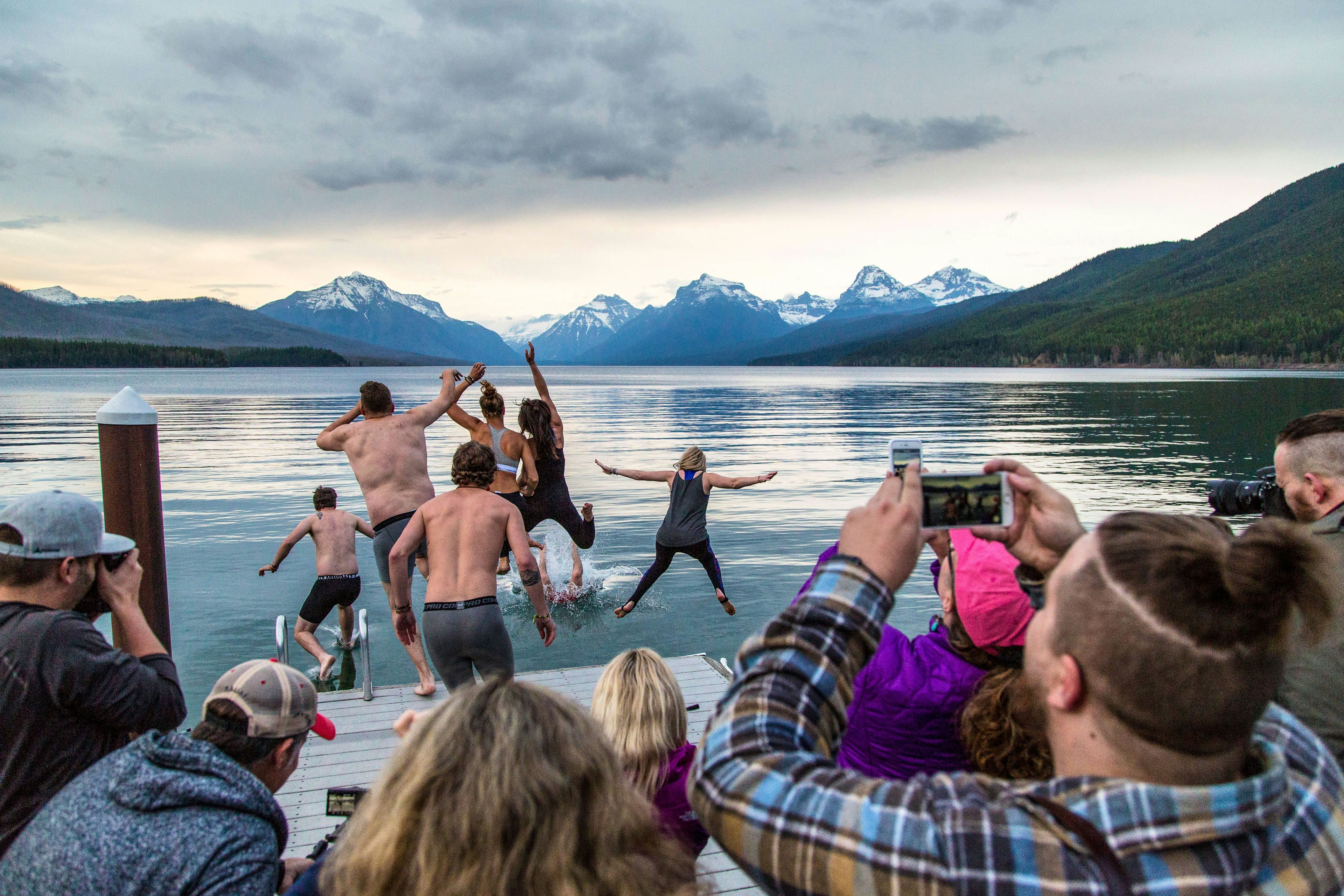 People leaving into water at Glacier National Park Montana NPS