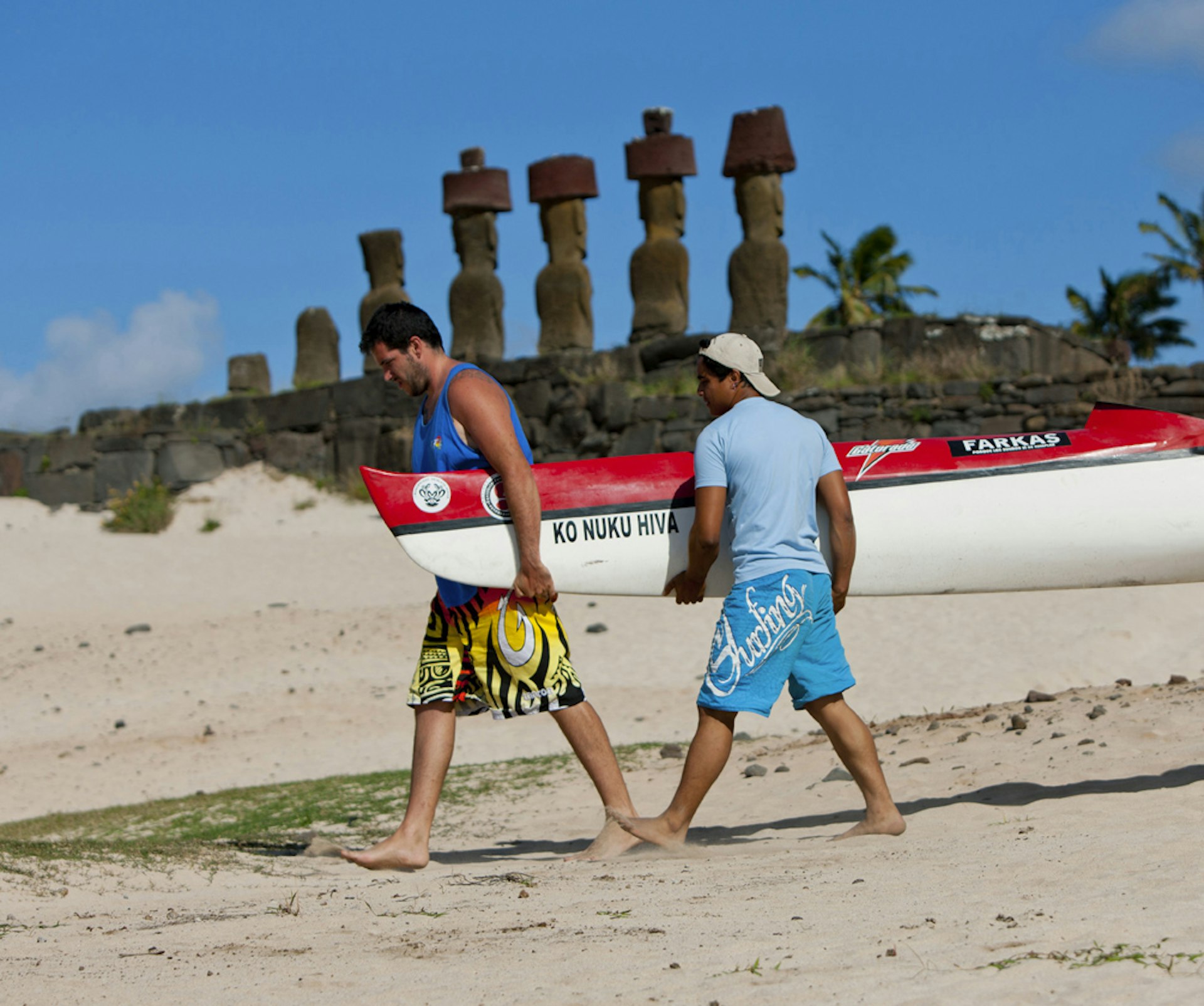 Men carrying kayak on Anakena Beach on Rapa Nui (Easter Island), Chile