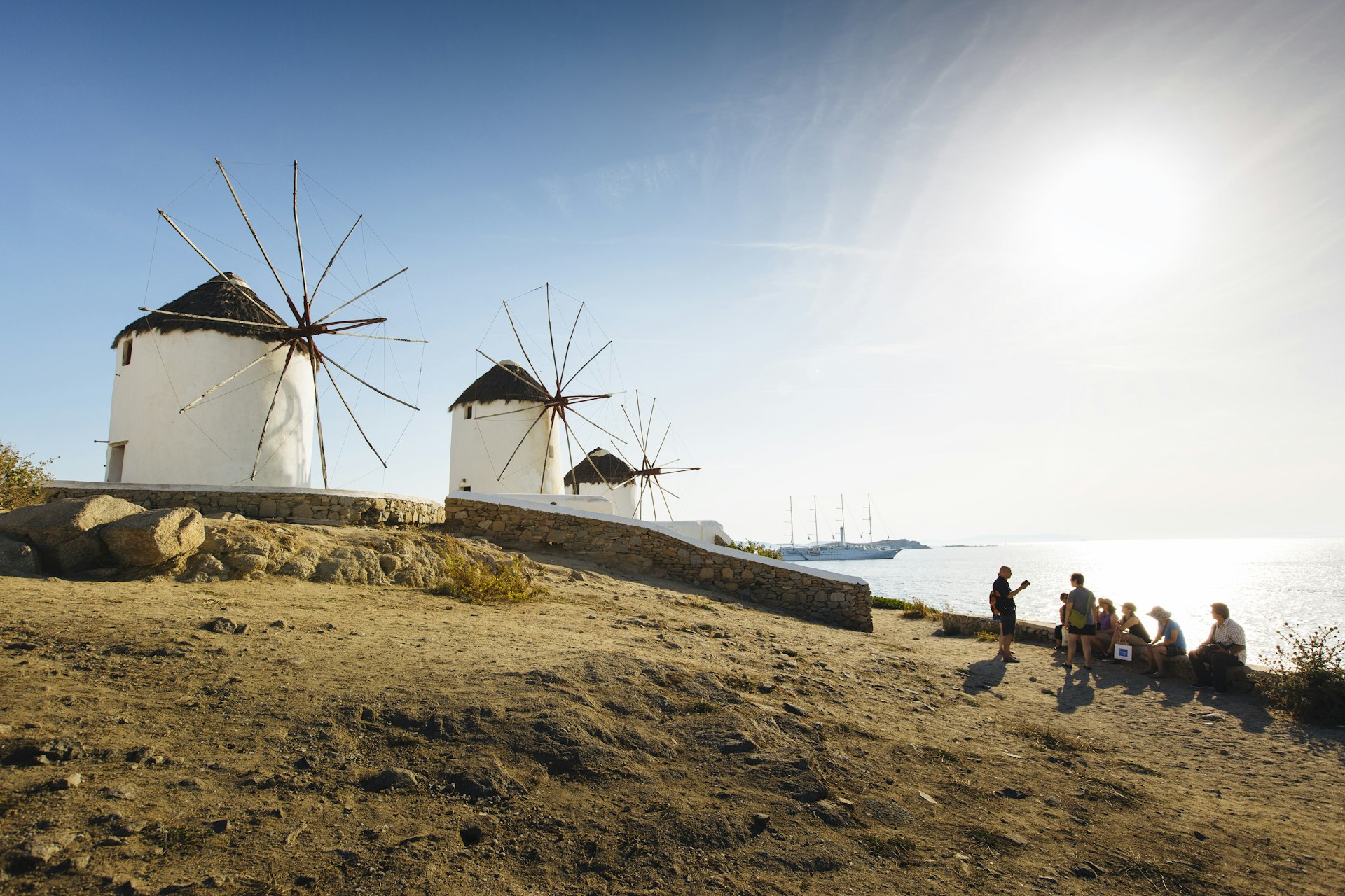 Hikers admire the windmills of Mykonos, Greece