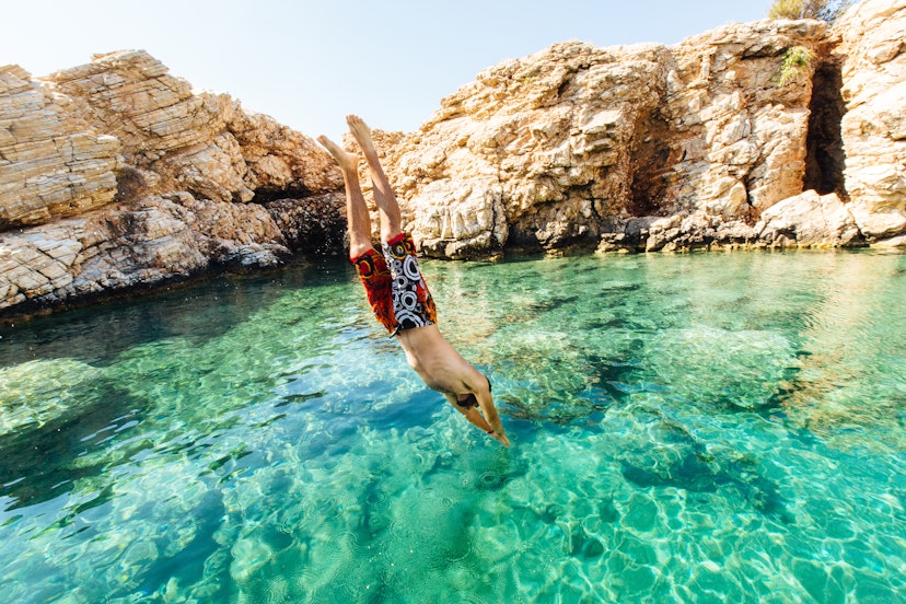 Man diving into clear water at Paros, Greece