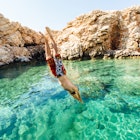 Man diving into clear water at Paros, Greece