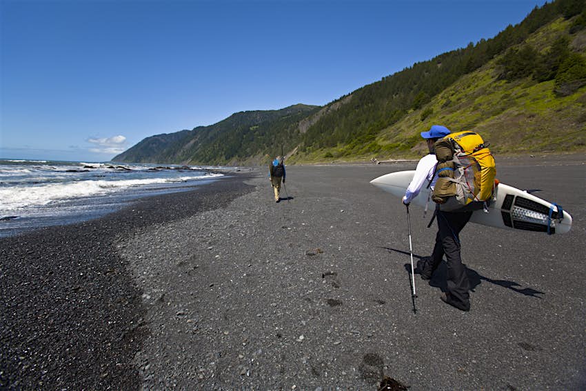 Two men backpack and surf on The Lost Coast, California.