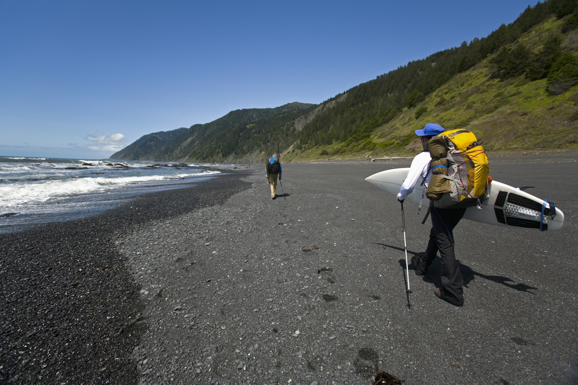 Two men backpack and surf on the Lost Coast in California