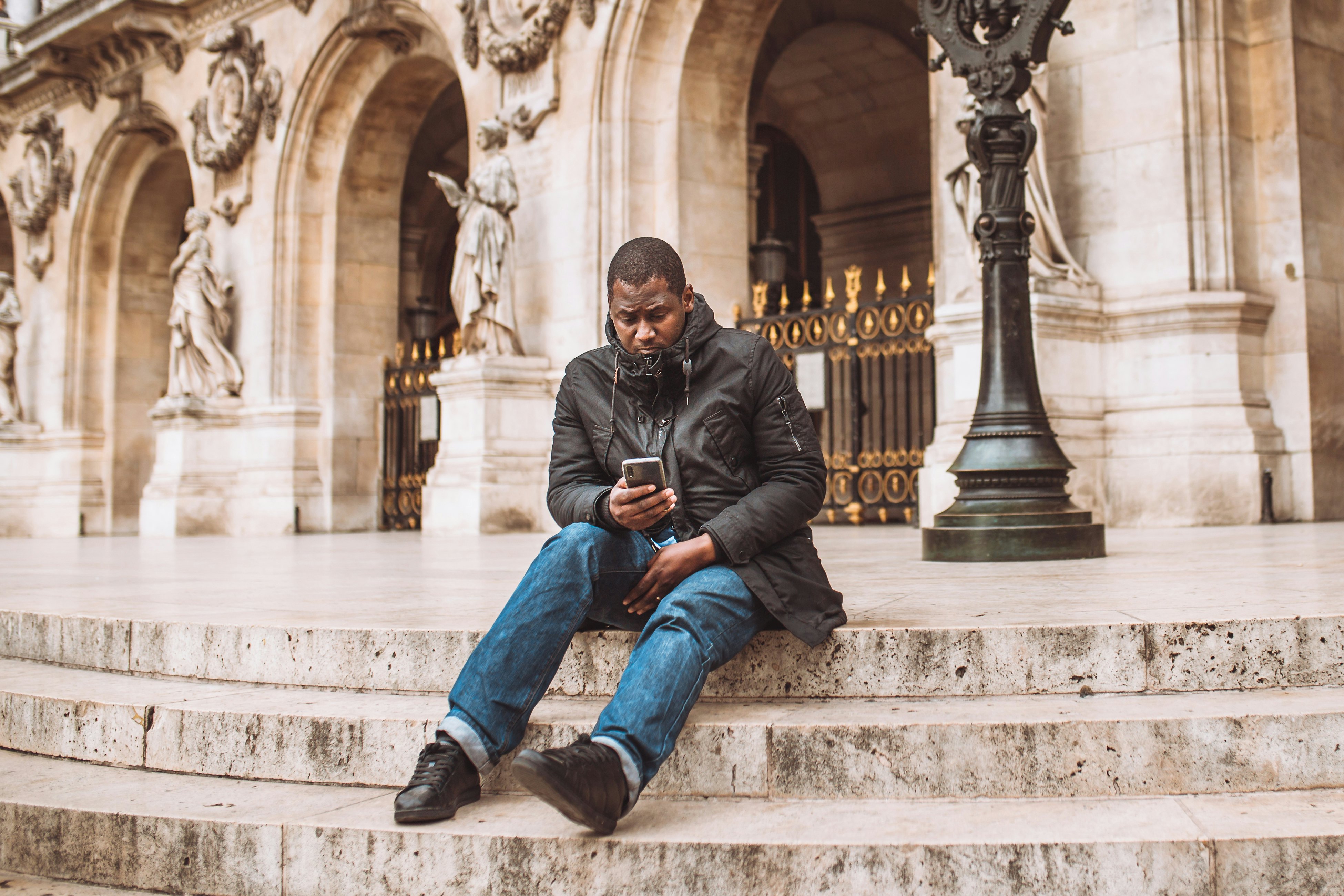 Man using phone while sitting on steps