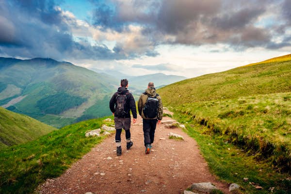 two people walking on a path outdoors