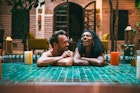 Multiracial couple relaxing in a swimming pool
