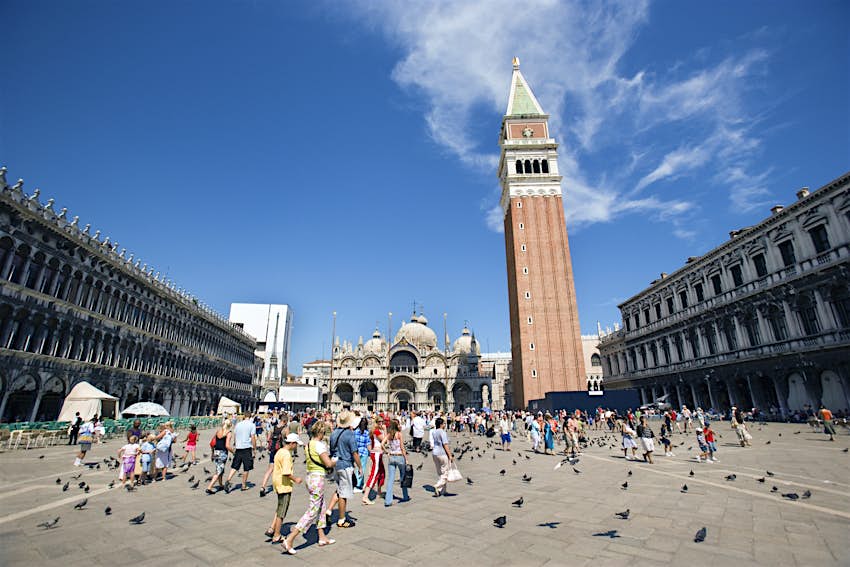 Piazza San Marco in Venice full of visitors with the Campanile Bell Tower dominating the view