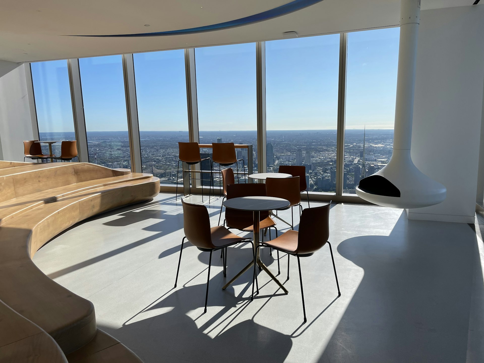 A seating area in a high-rise skyscraper, with views overlooking Manhattan